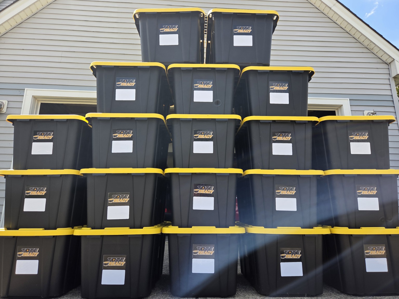A full wall of black and yellow Tote Ready moving totes